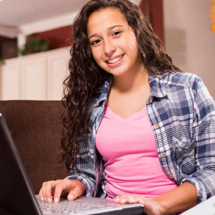 Young woman on her laptop taking a virtual college course.
