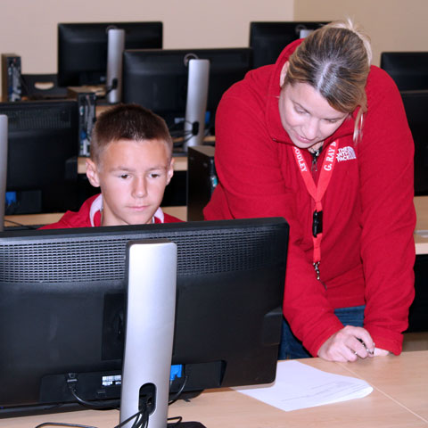 Young student taking a computer course at Cayuga.