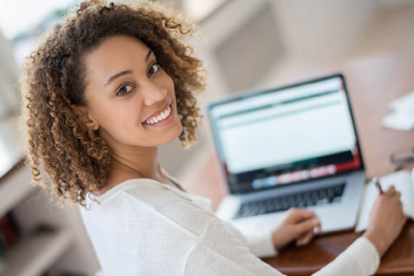 Young woman on a computer registering for class