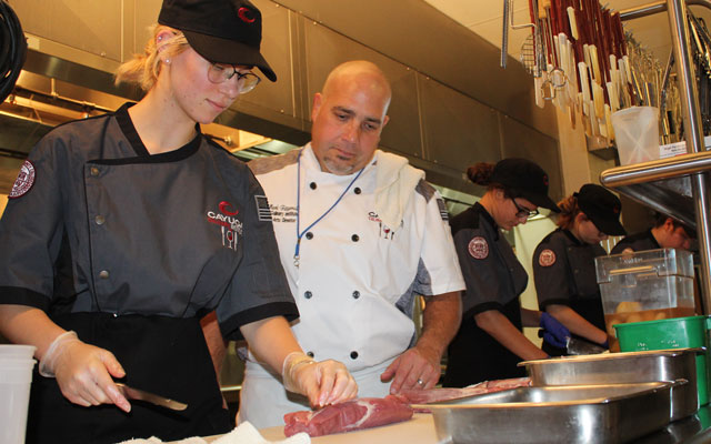 Culinary Arts student working with instructor