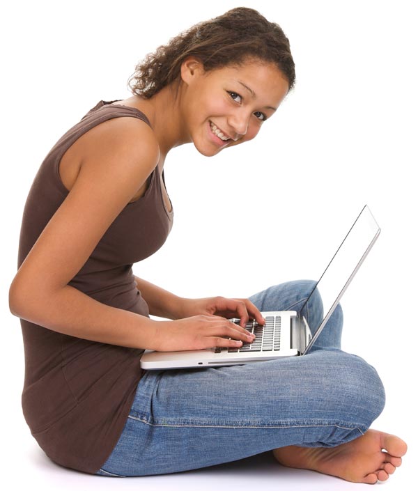 Young student sitting on floor working on a laptop