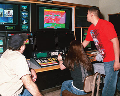 Students working in the Telcom studio on a control board