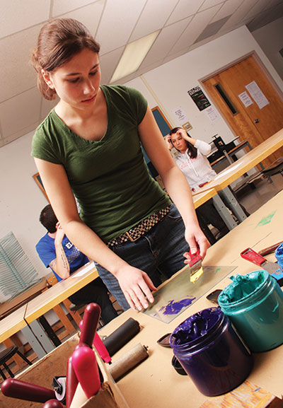 Student in art class working on her painting project